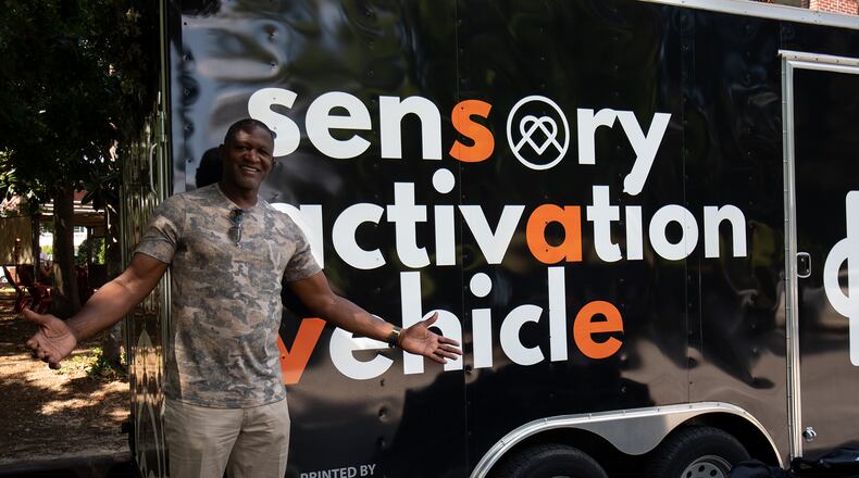 Dominique Wilkins in front of the Sensory Activation Vehicle. 
(Courtesy of KultureCity)