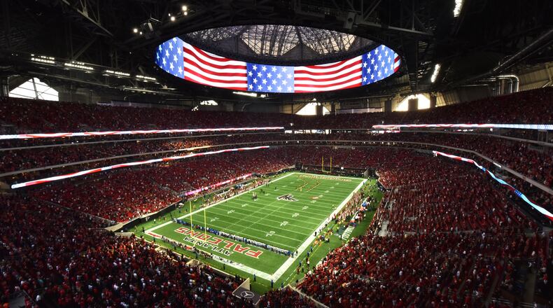 Atlanta Falcons fans cheer before an exhibition game against the Arizona Cardinals at the new Mercedes-Benz Stadium on Aug. 26. HYOSUB SHIN / HSHIN@AJC.COM