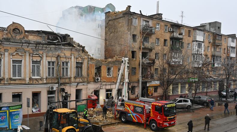 Rescue workers clear the rubble of a residential building which was heavily damaged after a Russian strike in Odesa, Ukraine, Tuesday, Jan. 27, 2026. (AP Photo/Michael Shtekel)