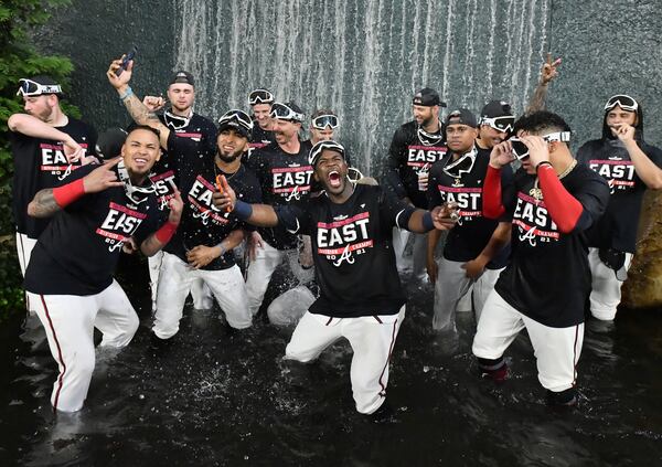 September 30, 2021 Atlanta - Atlanta Braves players celebrate after winning the NL East at Truist Park on Thursday, September 30, 2021. Atlanta Braves won 5-3 over Philadelphia Phillies. (Hyosub Shin / Hyosub.Shin@ajc.com)