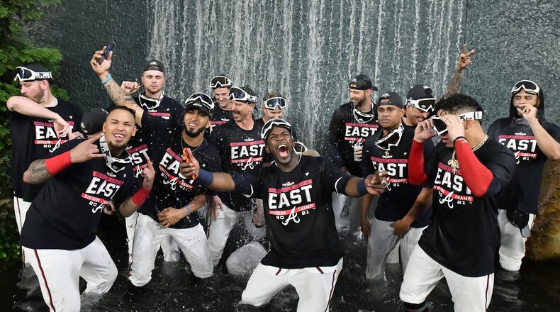 September 30, 2021 Atlanta - Atlanta Braves players celebrate after winning the NL East at Truist Park on Thursday, September 30, 2021. Atlanta Braves won 5-3 over Philadelphia Phillies. (Hyosub Shin / Hyosub.Shin@ajc.com)