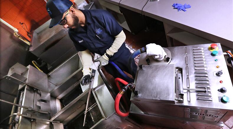 Filta lead technician Donnell Collier users a mobile filtration unit to filter fry oil at a concession stand in the Georgia World Congress Center on Thursday, Jan. 17, 2019, in Atlanta.