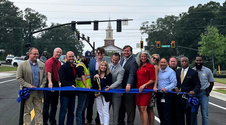 Roswell Mayor Pro Tem Christine Hall readies to cut the ribbon to reopen Oxbo Road. She is joined by City Council members Lee Hills, Will Morthland and Mike Palermo. Transportation Director Jeffrey Littlefield is beside the mayor pro tem. Courtesy City of Roswell