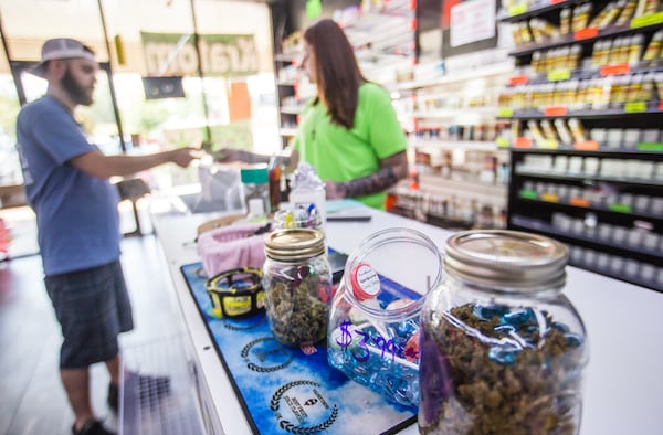 Twisted Vapes in the Boothe's Crossing strip mall is doing relatively well selling vape juice, CBD flowers, infused lollipops and tobacco products. Nancy Bradberry, the store’s manager, said, “People are literally trapped at home with nothing to do.” (Jenni Girtman for The Atlanta Journal-Constitution)