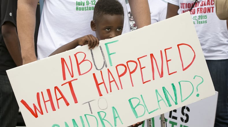 William Mitchell, 5, of Houston, holds a sign at a rally at the Waller County Jail in Hempstead on Friday to protest the death of Sandra Bland, who was found dead in the jail.