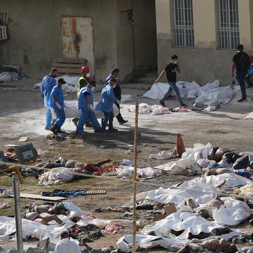EDS NOTE: GRAPHIC CONTENT - Emergency workers gather the bodies of earthquake victims in the parking lot of a hospital three days after twin earthquakes struck, in La Guaira, Venezuela, Saturday, June 27, 2026. (AP Photo/Matias Delacroix)