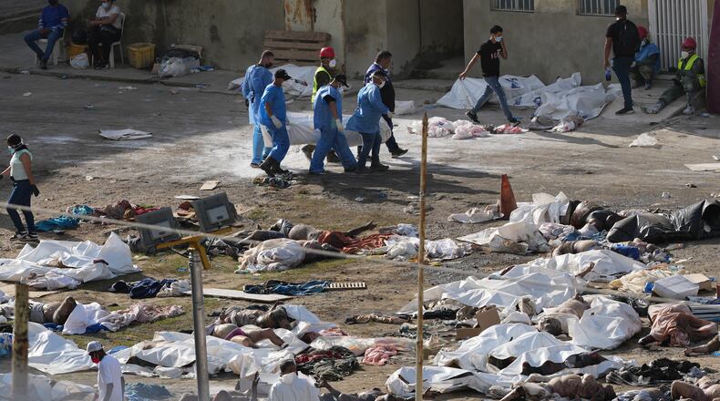EDS NOTE: GRAPHIC CONTENT - Emergency workers gather the bodies of earthquake victims in the parking lot of a hospital three days after twin earthquakes struck, in La Guaira, Venezuela, Saturday, June 27, 2026. (AP Photo/Matias Delacroix)