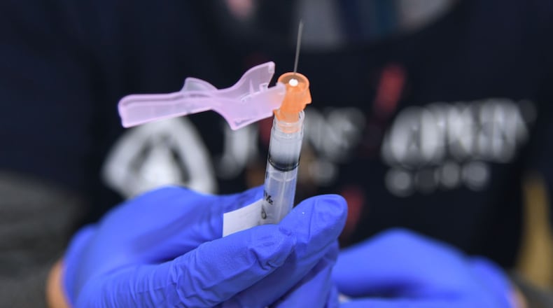 Joshua Chou, a pharmacist with Johns Hopkins Medicine, prepares a Moderna vaccine dose at a vaccine clinic in east Baltimore's Southern Baptist Church. April 10, 2021 (Barbara Haddock Taylor/Baltimore Sun/TNS)