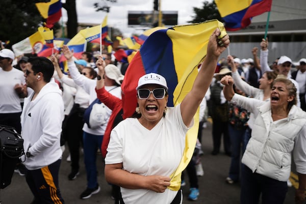 People march to the clinic where Colombian Senator Miguel Uribe Turbay is being treated after he was shot, in Bogota, Colombia, Sunday, June 8, 2025. (AP Photo/Ivan Valencia)