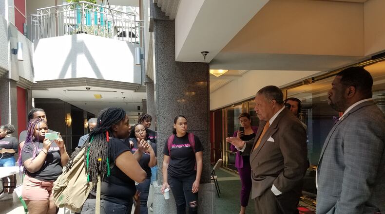 Fulton County commissioners Robb Pitts (center) and Marvin Arrington talk to protesters including Mary Hooks, co-director of Southerners on New Ground, about conditions at the jail. ARIELLE KASS/AKASS@AJC.COM