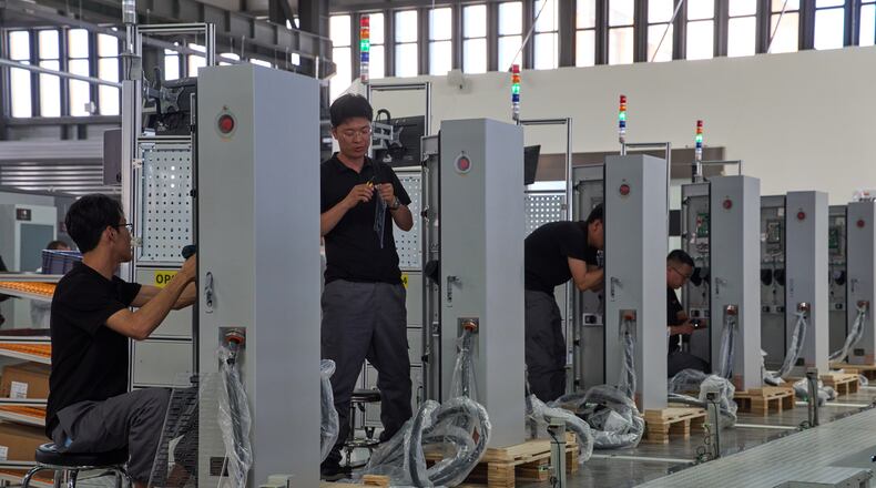 FILE - Workers assemble charging stations at the Mengma Intelligent Transportation Equipment Manufacturing Base in Hohot in northern China's Inner Mongolia province on Thursday, June 11, 2026. (AP Photo/Ng Han Guan, file)