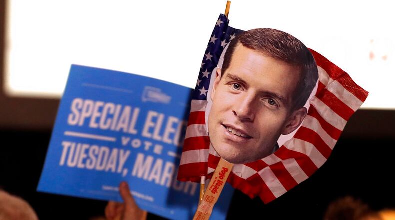 Supporters of Conor Lamb, the Democratic candidate for the March 13 special election in Pennsylvania's 18th Congressional District hold signs during his election night party in Canonsburg, Pa., Wednesday, March 14, 2018. Rattled Republicans were hit with the reality check Wednesday in the startling strong performance of a fresh-faced Democrat deep in Trump country.
(AP Photo/Gene J. Puskar)