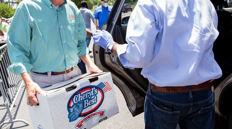 Georgia Agriculture Commissioner Gary Black (left) works alongside DeKalb County CEO Michael Thurmond to distribute the 600 boxes of fresh produce. (Jenni Girtman for Atlanta Journal Constitution)