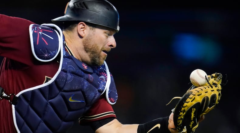 Arizona Diamondbacks catcher Stephen Vogt tries to make the catch on a foul ball hit by San Francisco Giants' Steven Duggar during the eighth inning of a baseball game Friday, July 2, 2021, in Phoenix. (AP Photo/Ross D. Franklin)