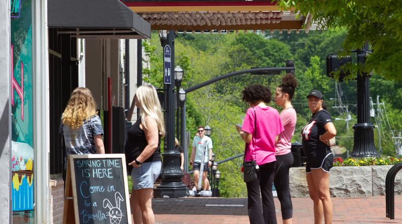 People stand in line for ice cream at Sarah Jean's Ice Cream on the Marietta Square Saturday, April 25, 2020. STEVE SCHAEFER / SPECIAL TO THE AJC
