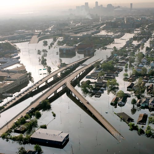 FILE - Floodwaters from Hurricane Katrina fill the streets near downtown New Orleans on Aug. 30, 2005. (AP Photo/David J. Phillip, File)