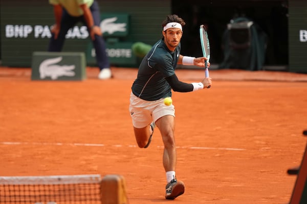 Italy's Lorenzo Musetti plays a shot against Frances Tiafoe of the U.S. during their quarterfinal match of the French Tennis Open at the Roland-Garros stadium in Paris, Tuesday, June 3, 2025. (AP Photo/Aurelien Morissard)