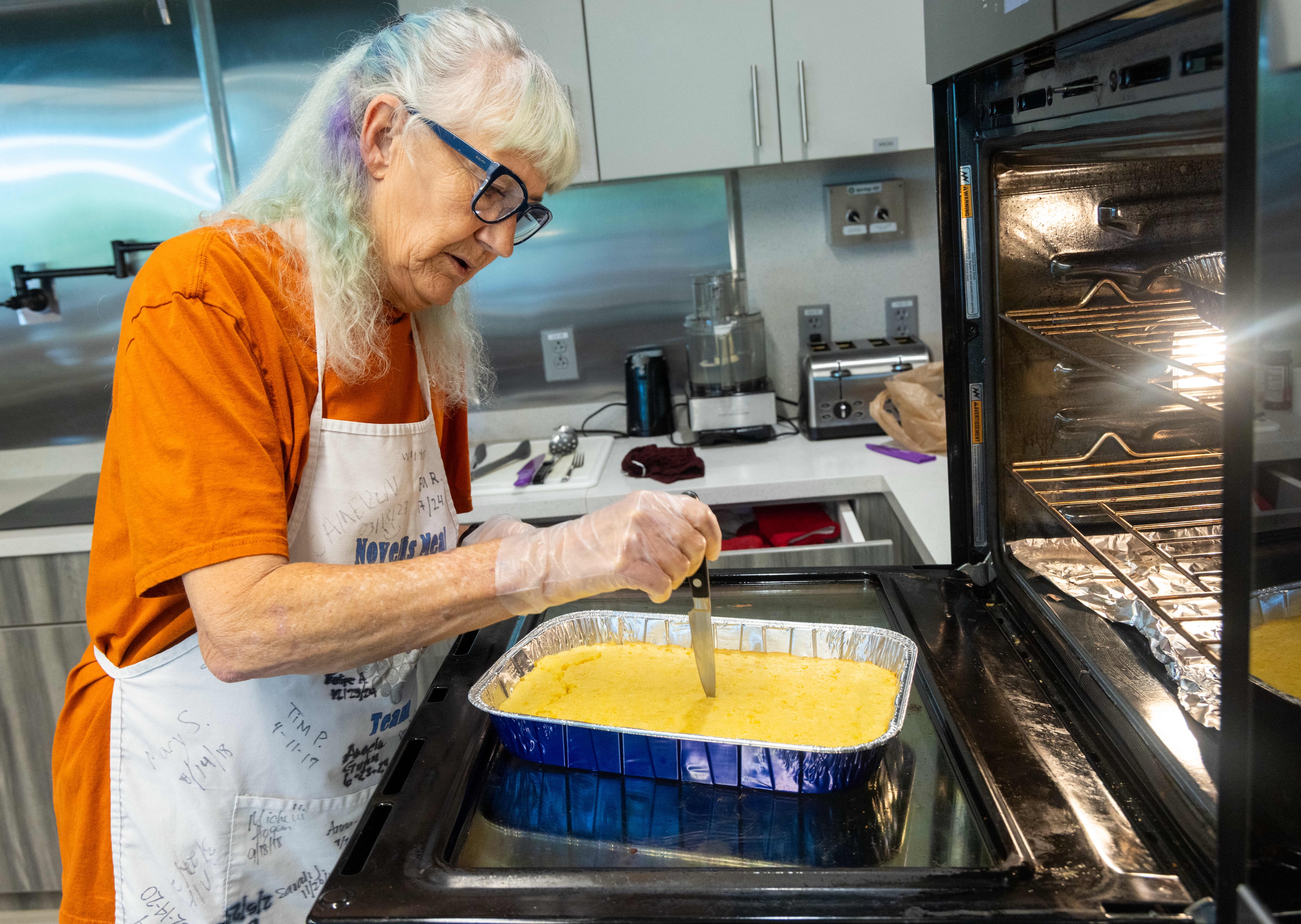 Volunteer Mary Stockstill checks her homemade cornbread at the Ronald McDonald House. Since 2017, Stockstill has worked with Atlanta-based Novelis, which helps provide home-cooked meals to families with sick or injured children staying at the house. (Phil Skinner for the AJC)