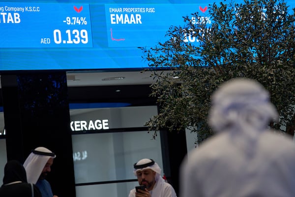 Emiratis are seen in the Dubai Financial Market in Dubai, United Arab Emirates, Monday, April 7, 2025. (AP Photos/Fatima Shbair)