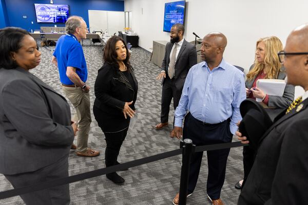 Fulton County elections board chair Sherri Allen (center) speaks to sheriff candidate Charles Rambo during Tuesday's meeting.