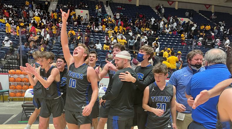 Towns County players and coaches celebrate their 64-60 victory over Hancock Central in the Class A Public boys basketball championship game Saturday, March 13, 2021, at Macon Coliseum.