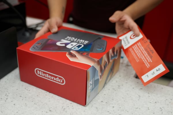 A customer receives the new Nintendo Switch 2 video game console at a Target store on Thursday, June 5, 2025 in Chicago. (AP Photo/Kiichiro Sato)