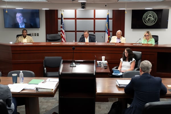 The Georgia Public Service Commission, with vice-chairman Tim Echols on the remote screen, meets in Atlanta on Tuesday, July 15, 2025. (Ben Gray for the AJC)