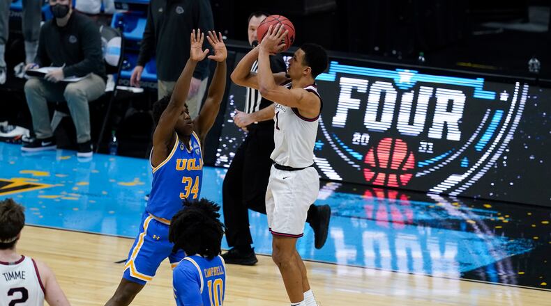 Gonzaga guard Jalen Suggs (1) shoots over UCLA guard David Singleton (34) to win the game during overtime in a men's Final Four NCAA college basketball tournament semifinal game, Saturday, April 3, 2021, at Lucas Oil Stadium in Indianapolis. Gonzaga won 93-90. (AP Photo/Darron Cummings)