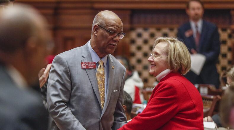 Rep. Sharon Cooper (right), R-Marietta, is congratulated by Rep. Calvin Smyre, D-Columbus, in February after House passage of her bill. Smyre spoke in support of it. The Georgia Senate will now consider a revised version of HB 987, which would help protect seniors living in assisted living communities and large personal care homes. Bob Andres / robert.andres@ajc.com