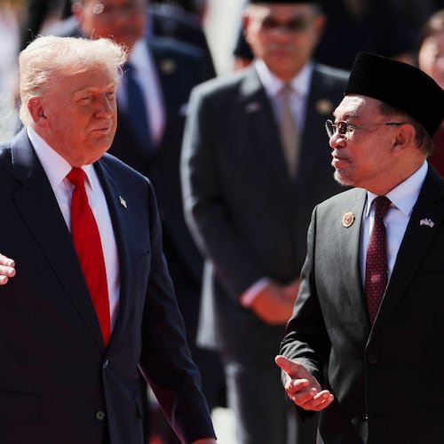 U.S. President Donald Trump talks with Malaysia Prime Minister Anwar Ibrahim as he arrives at Kuala Lumpur International Airport to attend the 47th Association of Southeast Asian Nations (ASEAN) summit in Kuala Lumpur, Malaysia, Sunday, Oct. 26, 2025. (Hasnoor Hussain/Pool Photo via AP)