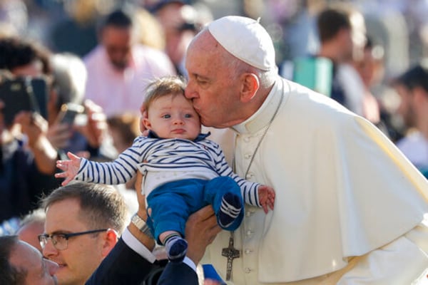 FILE - Pope Francis kisses a baby as he arrives for his weekly general audience, in St. Peter's Square, at the Vatican, Wednesday, Oct. 23, 2019. (AP Photo/Andrew Medichini, file)