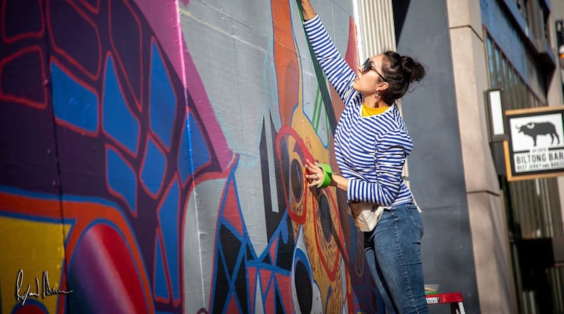 Carla Contreras at work on her mural for the Shops Buckhead Atlanta. Photo credit: Carla Contreras
