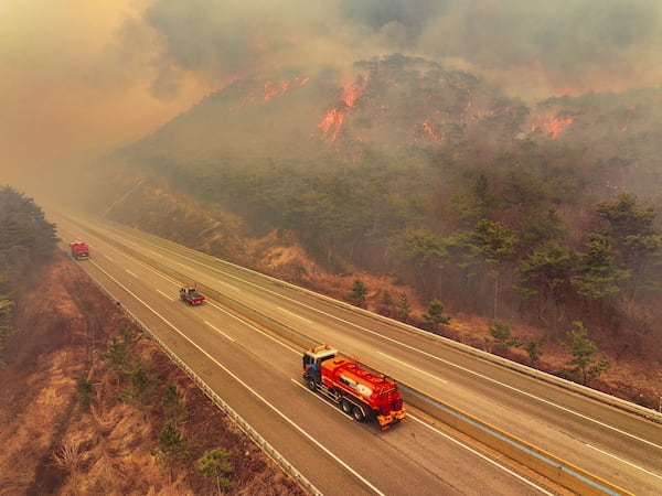 A road is closed as a wildfire fueled by strong winds spreads in Uiseong, South Korea, Monday, March 24, 2025. (Yoon Gwan-shick/Yonhap via AP)