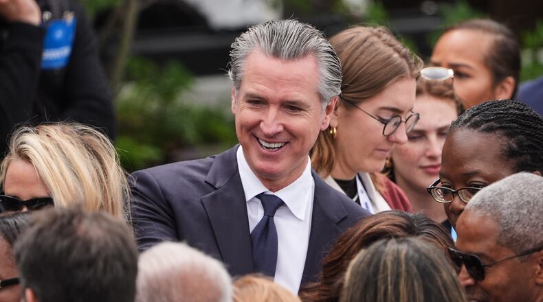 California Gov. Gavin Newsom mingles ahead of the Obama Presidential Center dedication ceremony Thursday, June 18, 2026, in Chicago. (AP Photo/Jeff Roberson)
