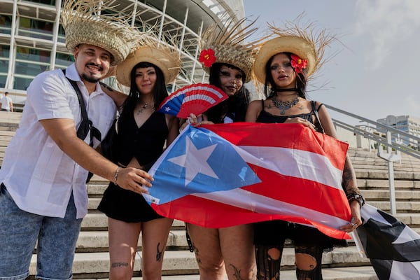 Bad Bunny fans pose for a photo before attending the first show of his 30-date concert residency at the Coliseo de Puerto Rico Jose Miguel Agrelot in San Juan, Puerto Rico, Friday, July 11, 2025. (AP Photo/Alejandro Granadillo)