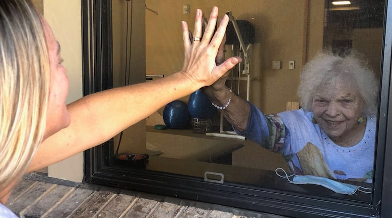Sally Hoynacki does a window visit with her mom Edna Taylor who lives in a nursing home in Dahlonega.
CONTRIBUTED