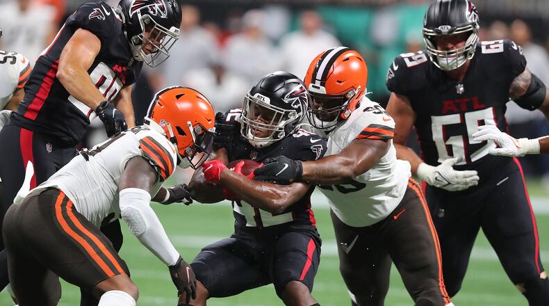 Falcons running back Caleb Huntley is sandwiched by Cleveland Browns defenders for short yardage during the first half Sunday, Aug. 29, 2021, in Atlanta. “Curtis Compton / Curtis.Compton@ajc.com”