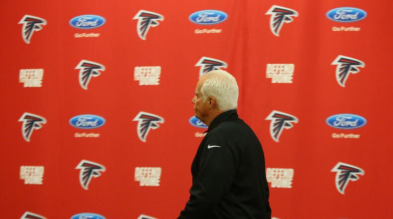 Falcons head coach Mike Smith, whose job could depend on the outcome of today's game, heads to the locker room before playing the Panthers in a football game for the NFC South title and a trip to the post season on Sunday, Dec. 28, 2014, in Atlanta. Curtis Compton / ccompton@ajc.com