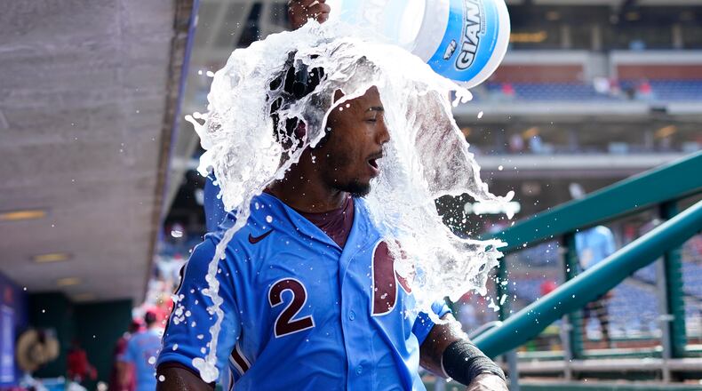 Philadelphia Phillies' Jean Segura, left, is doused by Jose Alvarado after hitting a game-winning two-run single off Atlanta Braves pitcher Chris Martin during the 10th inning of a baseball game, Thursday, June 10, 2021, in Philadelphia. (AP Photo/Matt Slocum)