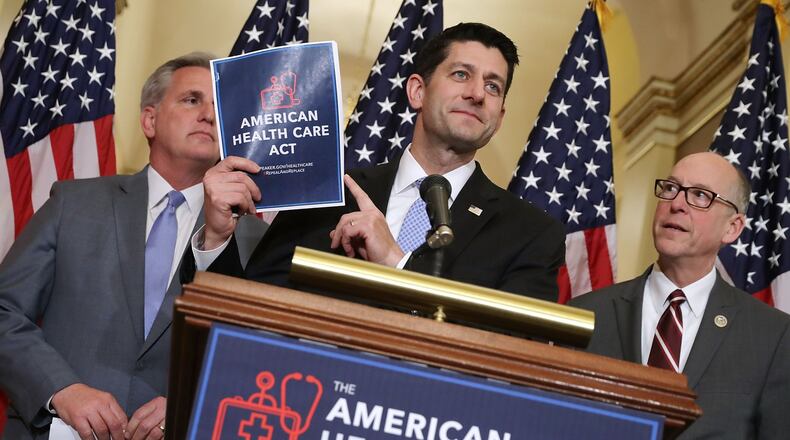 WASHINGTON, DC - MARCH 07: Speaker of the House Paul Ryan (R-WI) (C) holds up a copy of the American Health Care Act during a news conference with House Majority Leader Kevin McCarthy (R-CA) (L) and House Energy and Commerce Committee Chairman Greg Walden (R-OR) outside Ryan’s office in the U.S. Capitol March 7, 2017. (Photo by Chip Somodevilla/Getty Images)