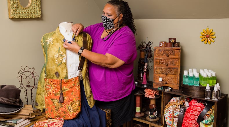 Susan Hurst of Marietta is a participant in a COVID-19 vaccine trial that will last two years and requires monthly doctor visits, treatments and data collection. Hurst stays busy at her day job working in finance and she's making reversible handbags, leather jewelry and belts and masks, which she was selling at local markets before the pandemic.  (Jenni Girtman for The Atlanta Journal-Constitution)