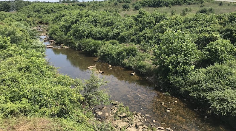 Flint River south of Hartsfield-Jackson International Airport, with the approach lights of the fifth runway in the background.
