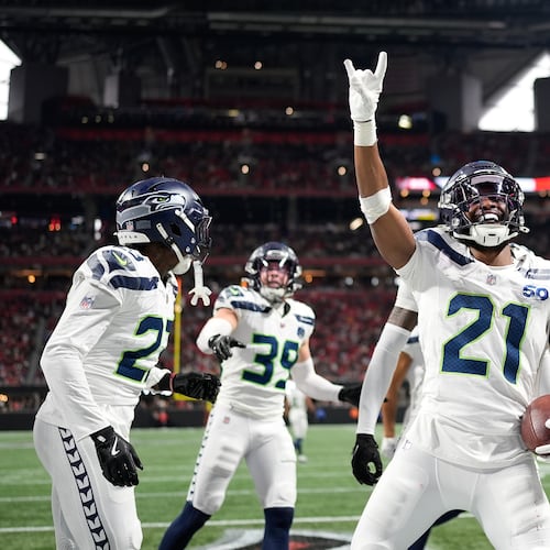 Seattle Seahawks cornerback Devon Witherspoon celebrates a fumble recovery against the Atlanta Falcons during the second half of an NFL football game, Sunday, Dec. 7, 2025, in Atlanta. (AP Photo/Mike Stewart)