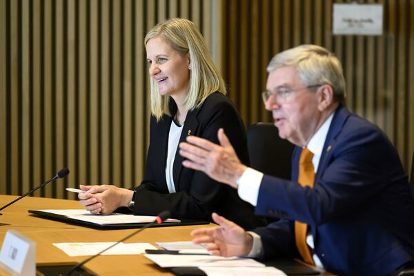 International Olympic Committee (IOC) President Thomas Bach, right, speaks next to the president-elect of the IOC Zimbabwean Kirsty Coventry, at the opening of the executive board meeting of the IOC, at the Olympic House, in Lausanne, Switzerland, Wednesday, April 9, 2025. (Laurent Gillieron/Keystone via AP)
