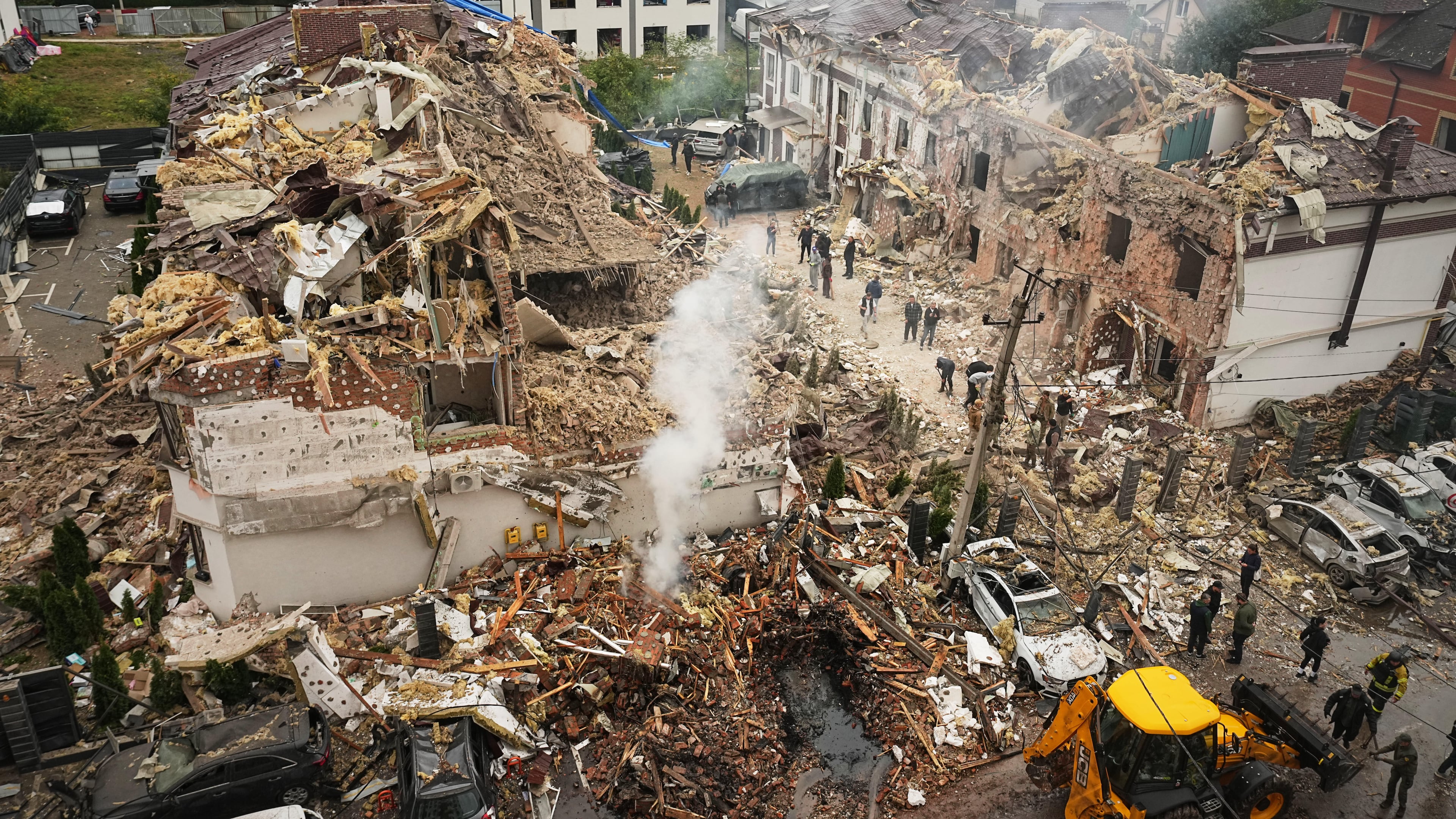 Rescuers work at the site of an apartment buildings damaged during a Russian attack in Kyiv, Ukraine, Sunday, Sept. 28, 2025. (AP Photo/Efrem Lukatsky)