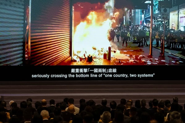 A video of the Anti-Extradition Bill movement in 2019 is displayed at the 5th anniversary of Hong Kong National Security Law Forum in Hong Kong, Saturday, June 21, 2025. (AP Photo/Chan Long Hei)