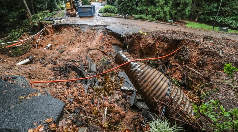 October 6, 2021, Cobb County: A flash flood watch remained in effect through late Wednesday night while the work on the washed-out road at the Watermark At East Cobb by Cortland apartments in Marietta had stopped because of the rain on Wednesday, Oct. 6, 2021. Now, Cobb County commissioners are continuing talks on changing how stormwater fees are calculated, over a year after flooding caused widespread damage. (John Spink / John.Spink@ajc.com)