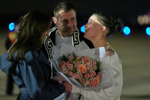 Ksenia Karelina and her fiancé, professional boxer Chris van Heerden, talk with Morgan Ortagus, deputy special presidential envoy to the Middle East, Thursday, April 10, 2025, at Joint Base Andrews, Md. (AP Photo/Alex Brandon)