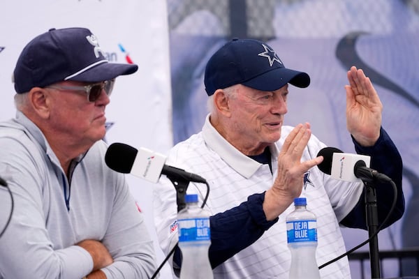 Jerry Jones, right, Dallas Cowboys owner, president, and general manager speaks to reporters as Stephen Jones, Cowboys co-owner, executive vice president, CEO, and director of player personnel listen during a news conference to open training camp Monday, July 21, 2025, in Oxnard, Calif. (AP Photo/Mark J. Terrill)