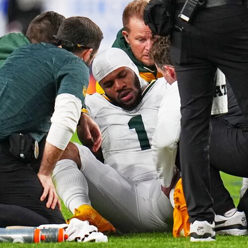 Green Bay Packers' Micah Parsons reacts after an injury during the second half of an NFL football game against the Denver Broncos Sunday, Dec. 14, 2025, in Denver. (AP Photo/Jack Dempsey)